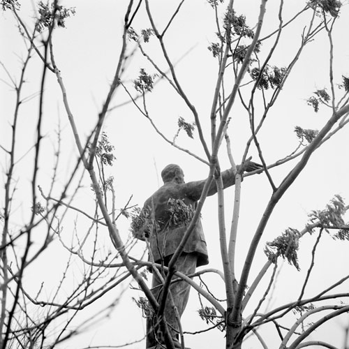 Statue of Lenin amongst trees in Memento Park, Budapest